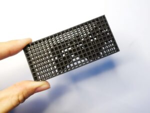 SLS 3D Printed Small Nylon Pieces Packaged with a Cage